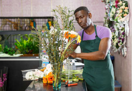 Florist making bouquet with gerberasの写真素材