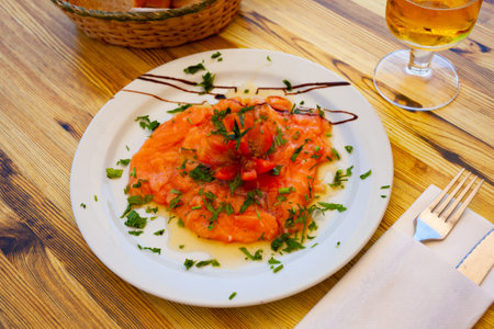Image of salmon carpaccio served with greens on plate