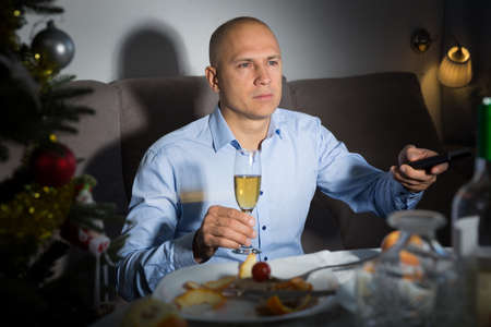 Man watching tv at Christmasの写真素材