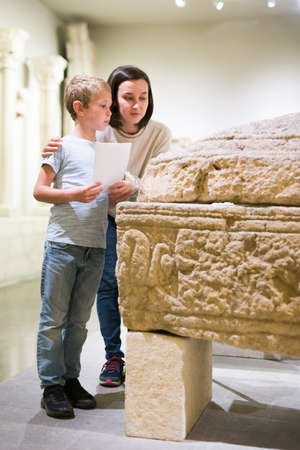 Woman and boy visiting sculptures exhibitionの写真素材