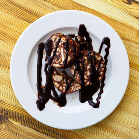 Sweet chocolate sausage of nuts and cookies with glazeの写真素材