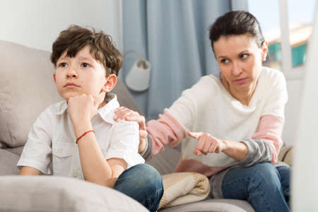 Frowning tweenager listening motherの写真素材