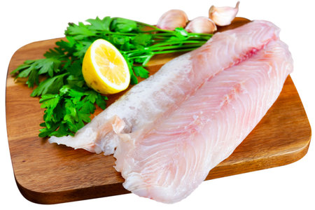 Raw perch fish fillet with parsley and lemonの写真素材