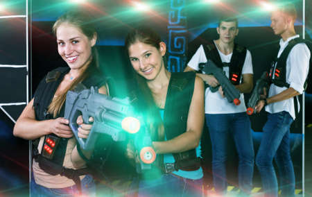 Two girls posing with laser gunsの写真素材