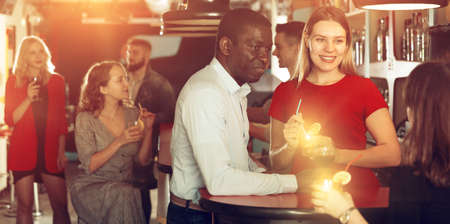 Couple are drinking cocktails and having fun in the nightclubの写真素材