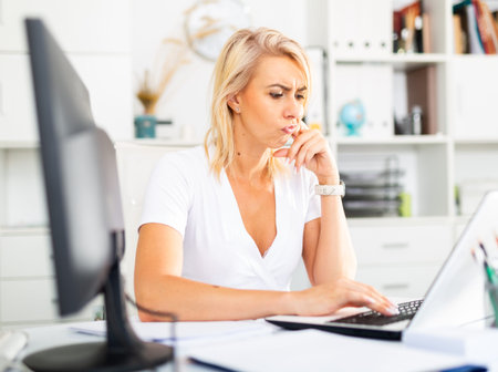 Tired businesswoman working with documents in office