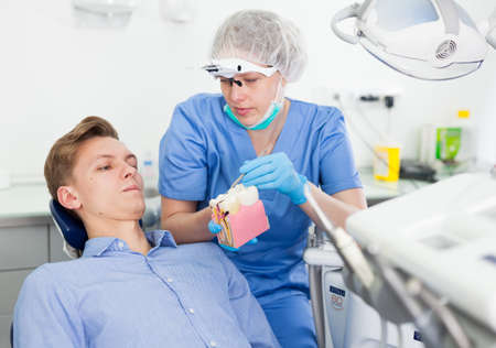 Orthodontist is telling about hygiene in dental clinicの写真素材