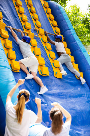 Mens competition on an inflatable slide Great race in an amusement park