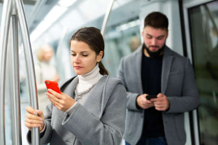 People browsing in smartphone in subwayの写真素材