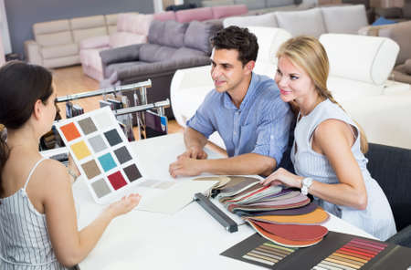 young couple are consulting with seller about the colors of furnitureの写真素材