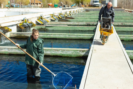 Male and female catching fish from reservoir