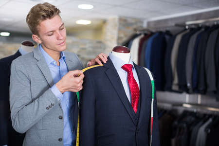 Adult male in shirt measuring jacketの写真素材