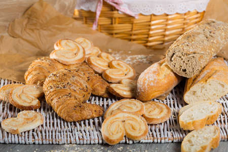 Various kinds of bread and bakery products on tableの写真素材