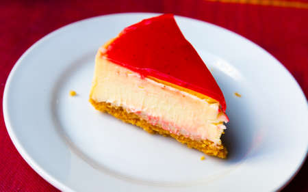 Slice of delicious classical cheesecake with fruity sauce servedの写真素材