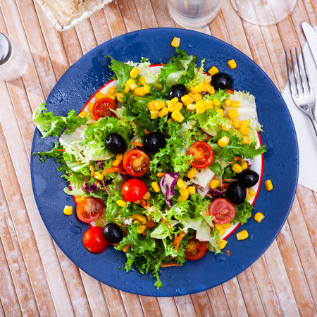 Mixed salad with corn, olives, cherry tomatoes and green lettuceの写真素材