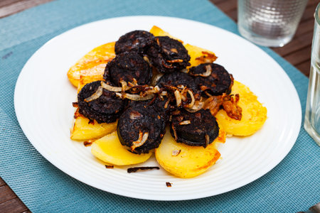 Blood sausages served with potato and onionの写真素材