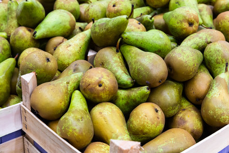 Fresh pears in wooden boxes