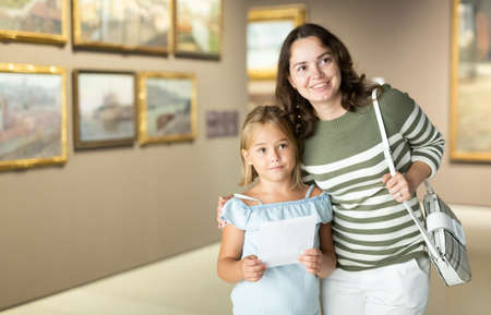 Mother and daughter exploring expositions in museumの写真素材