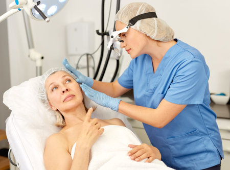 Doctor is examining mature woman patient before the procedure