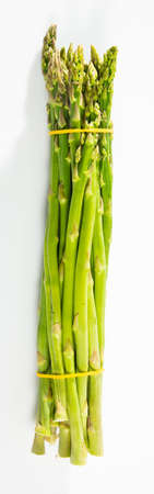 Raw fresh green asparagus isolated on a white backgroundの写真素材