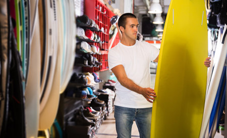 Man choosing surfboard i