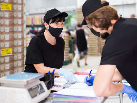 Workers of fruit packing facility signing documentsの写真素材