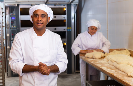 Portrait of confident latino chef in bakery