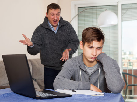 Father scolds his son for bad schooling