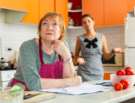 Upset elderly mother with dissatisfied adult daughterの写真素材