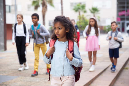 African american preteen girl walking to school on autumn dayの写真素材