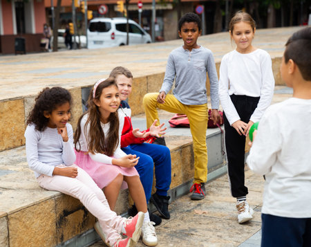 Cheerful tweens spending time together on city street