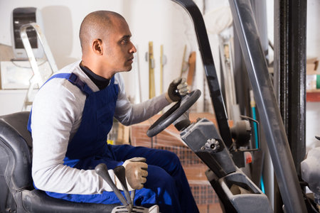 Forklift driver driving at hardware store