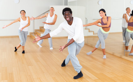 African-American practicing vigorous swing during group training