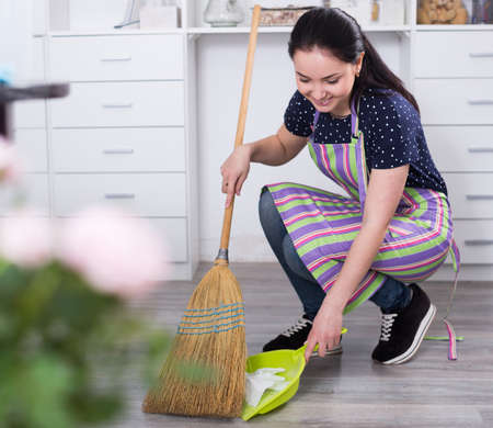 Girl sweeping garbageの写真素材