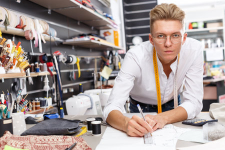 Tailor using tape measure for creating patternの写真素材