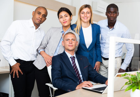 positive international group of managers in white office