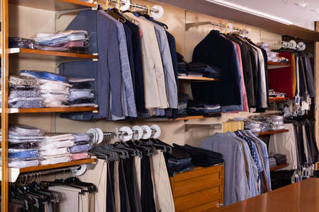 Men clothing store with variety of suit coatsの写真素材