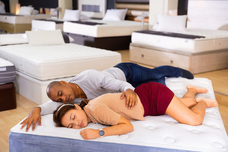 Husband and wife fell asleep on new mattress in a furniture store