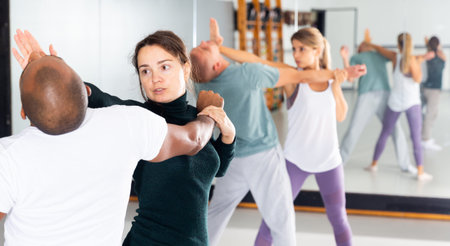 Woman and man practicing self defense techniques