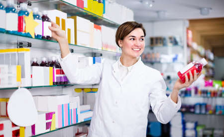 Adult girl is browsing rows of body care productsの写真素材