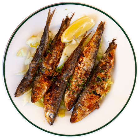 Fried sardines served with slice of lemonの写真素材
