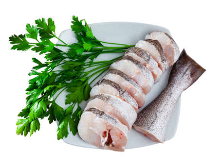 Fresh raw steaks of hake fish with greens and garlic, nobodyの写真素材