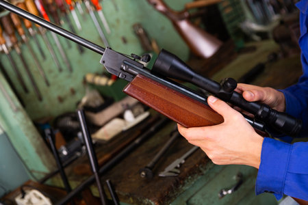 Installing telescopic sight on an automatic rifle in weapons workshop