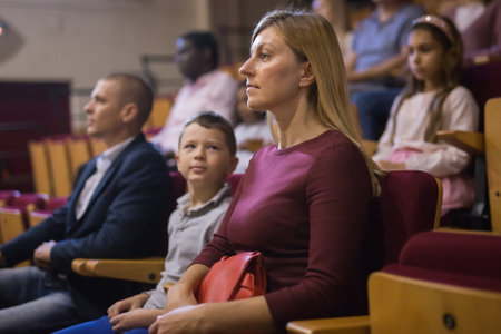 close up of european woman sitting at film in cinema auditoriumの写真素材