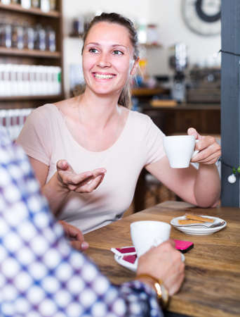 Female and male are having date in cafeの写真素材