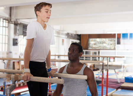 Coach helping boy doing exercises