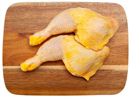 Natural raw chicken leg quarters with seasoningsの写真素材