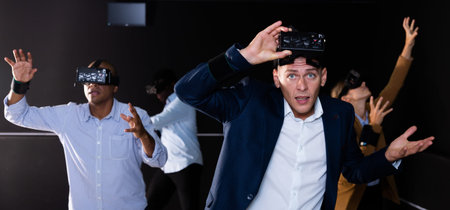 Man using virtual reality headset and gesturing
