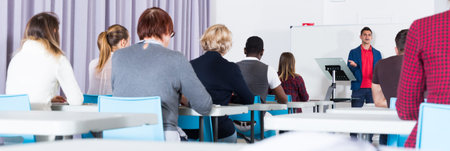 Students with teacher studying in classroom