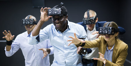 Group of friends are wearing virtual reality goggles in quest room